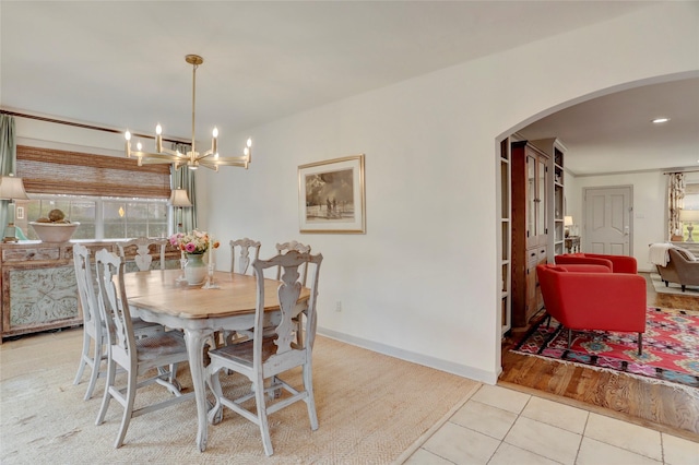 tiled dining space featuring a chandelier