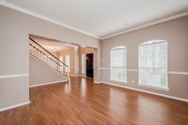 spare room with wood-type flooring and ornamental molding