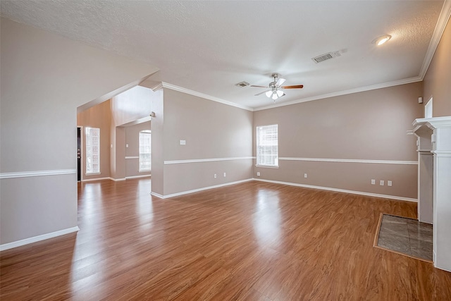 unfurnished living room featuring ornamental molding, hardwood / wood-style floors, a textured ceiling, and ceiling fan