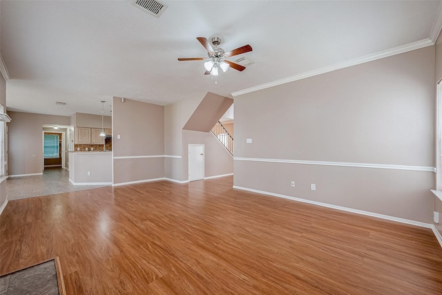 unfurnished living room with crown molding, ceiling fan, and light wood-type flooring