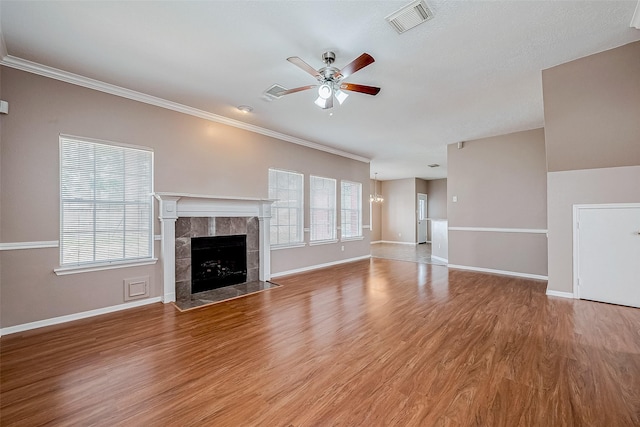 unfurnished living room featuring ceiling fan, a fireplace, light hardwood / wood-style floors, and a wealth of natural light