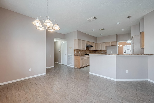 kitchen featuring tasteful backsplash, light brown cabinets, light hardwood / wood-style flooring, and a notable chandelier