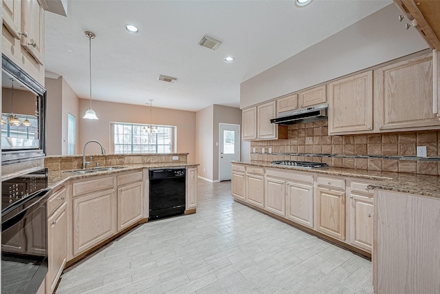 kitchen featuring sink, tasteful backsplash, decorative light fixtures, light brown cabinets, and black appliances