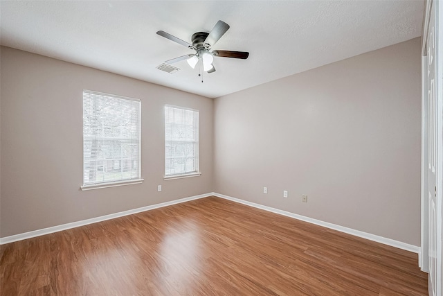 empty room featuring hardwood / wood-style flooring and ceiling fan