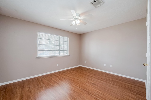 unfurnished room featuring hardwood / wood-style floors and ceiling fan