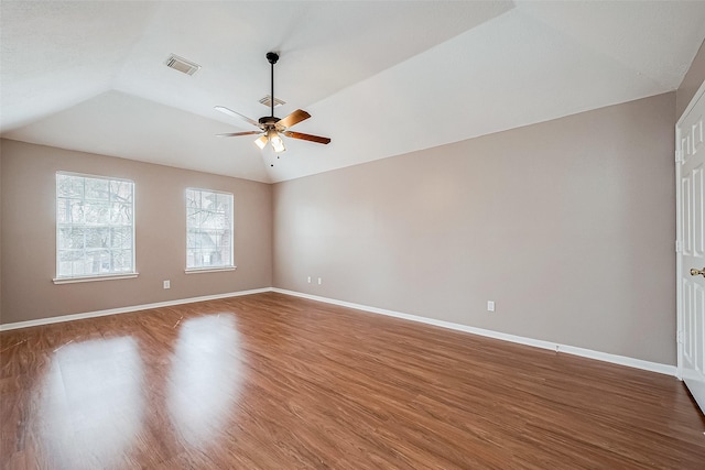 unfurnished room featuring wood-type flooring, lofted ceiling, and ceiling fan