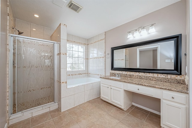 bathroom with vanity, tile patterned floors, and shower with separate bathtub