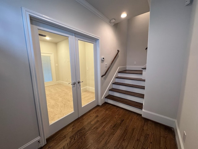 stairs with hardwood / wood-style flooring and french doors