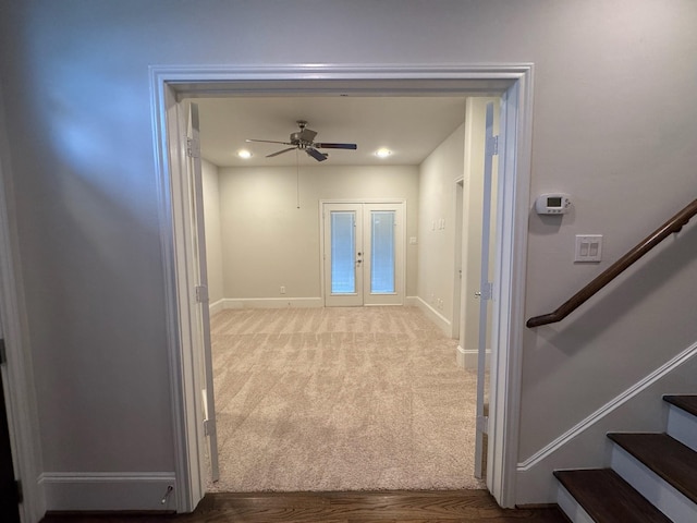 corridor featuring french doors and carpet flooring