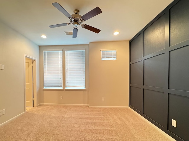 unfurnished bedroom with light colored carpet and ceiling fan