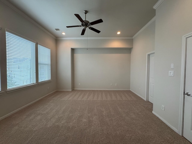 spare room with crown molding, light carpet, and ceiling fan