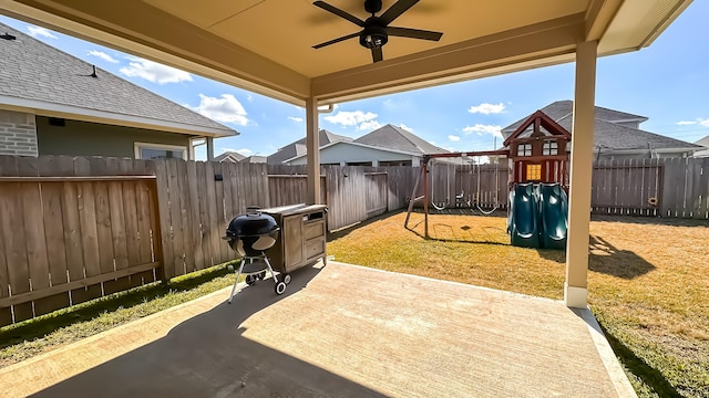 view of patio / terrace featuring a playground and ceiling fan