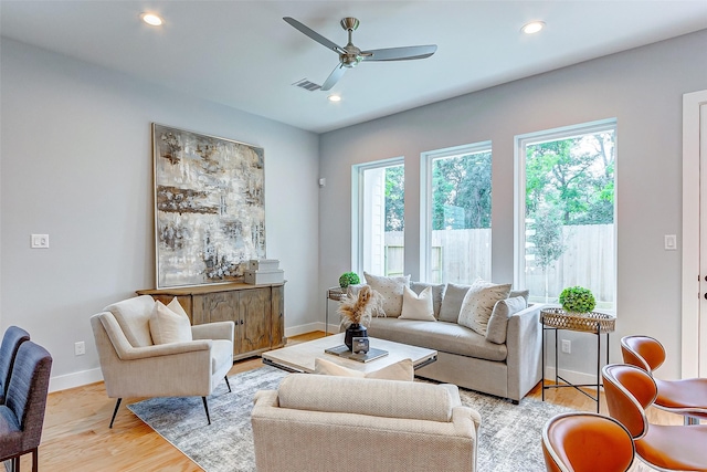 living room with ceiling fan and light wood-type flooring