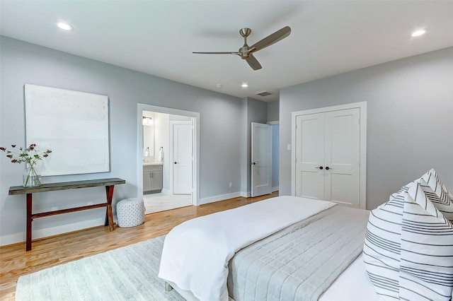 bedroom featuring connected bathroom, wood-type flooring, a closet, and ceiling fan