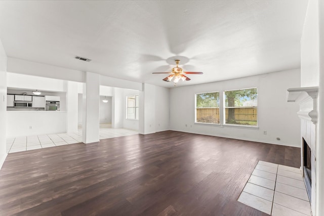 unfurnished living room featuring light hardwood / wood-style floors and ceiling fan