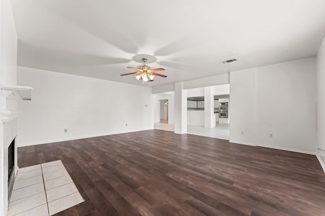 unfurnished living room with hardwood / wood-style flooring and ceiling fan