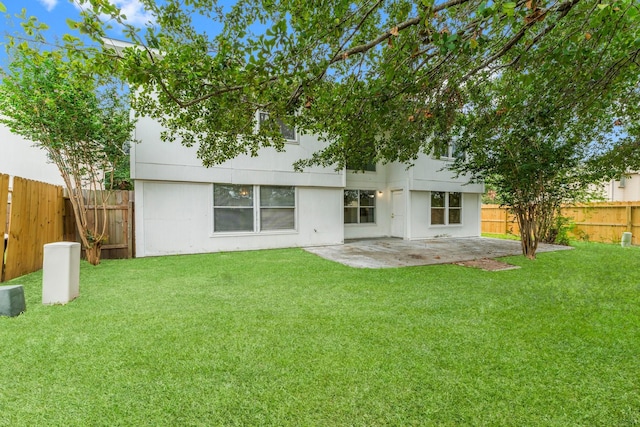 back of house featuring a patio and a lawn