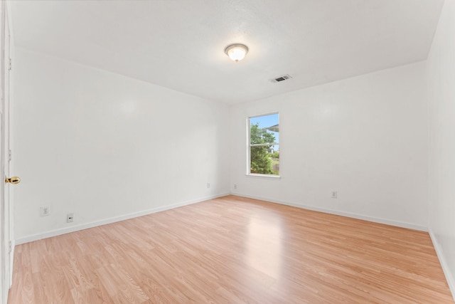 spare room with light hardwood / wood-style flooring