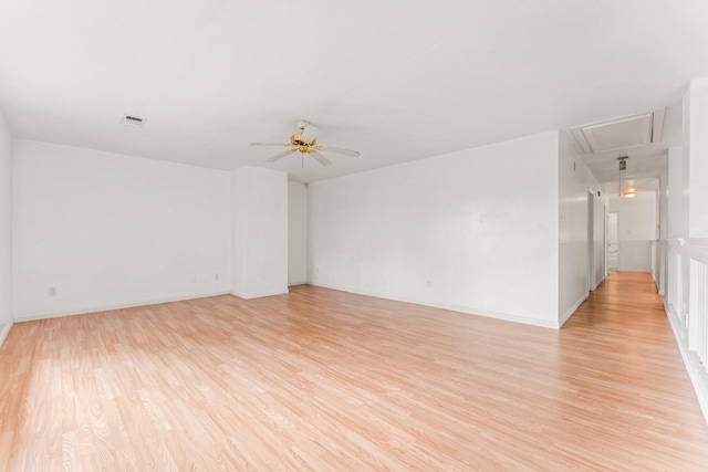 empty room featuring ceiling fan and light wood-type flooring