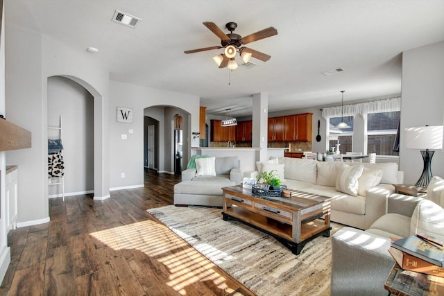 living room featuring dark hardwood / wood-style floors and ceiling fan