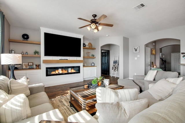 living room with dark hardwood / wood-style floors and ceiling fan