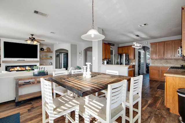 dining space featuring ceiling fan and dark hardwood / wood-style flooring