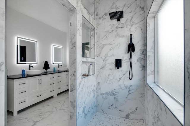 bathroom featuring vanity and tiled shower