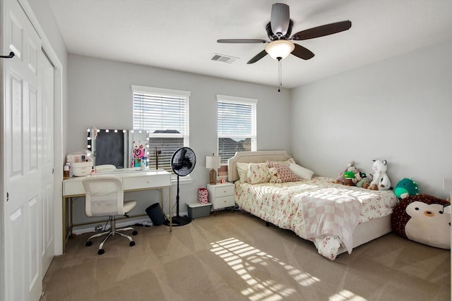 bedroom with ceiling fan, carpet flooring, and a closet