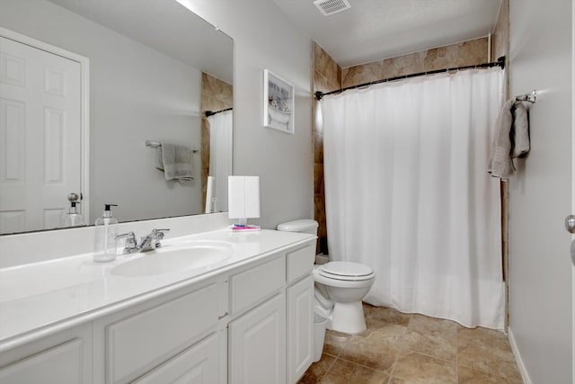 bathroom with vanity, toilet, and walk in shower