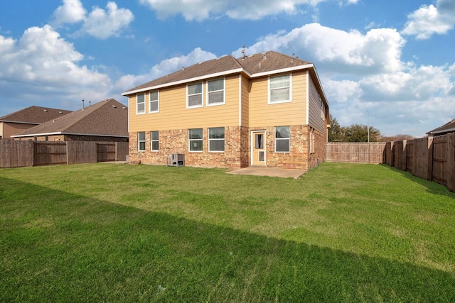 rear view of house featuring a yard and a patio area