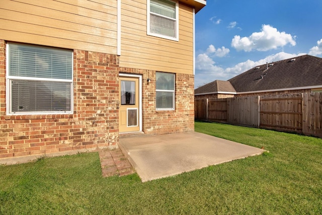 rear view of property with a patio and a yard