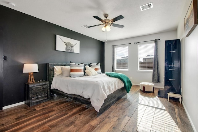 bedroom with dark hardwood / wood-style floors and ceiling fan