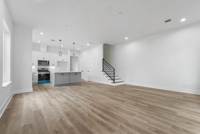 unfurnished living room with light hardwood / wood-style floors