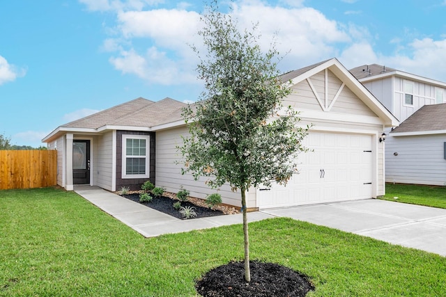 view of front of property featuring a garage and a front yard