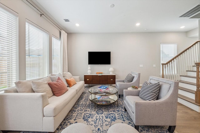 living room with a healthy amount of sunlight and light hardwood / wood-style floors