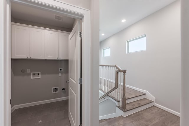 washroom with cabinets, gas dryer hookup, electric dryer hookup, and hookup for a washing machine