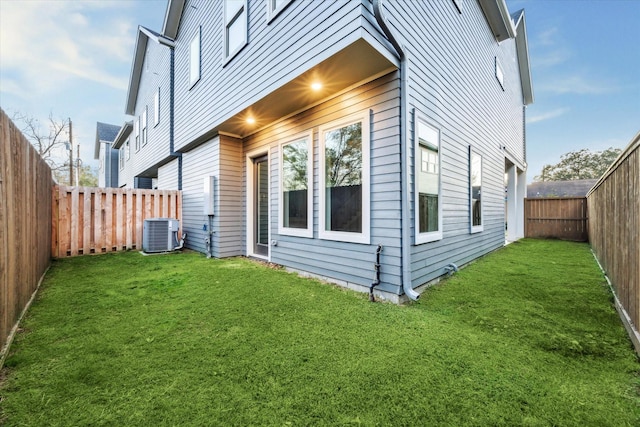 view of property exterior with central AC unit and a lawn