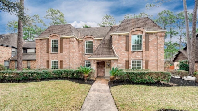 french provincial home with a front yard