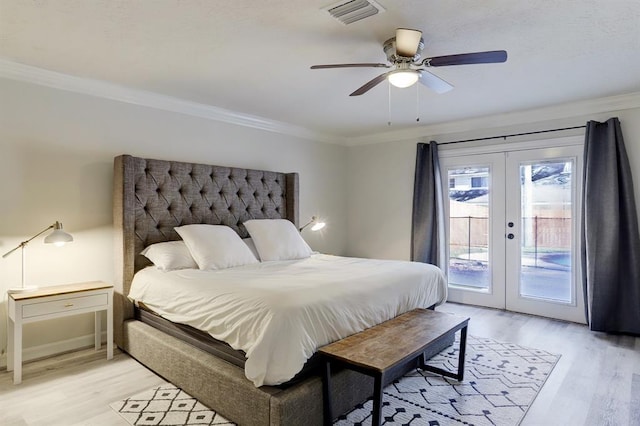 bedroom featuring french doors, ornamental molding, access to exterior, and light wood-type flooring