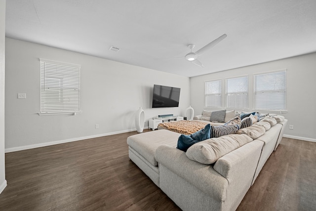 living room featuring dark wood-type flooring and ceiling fan