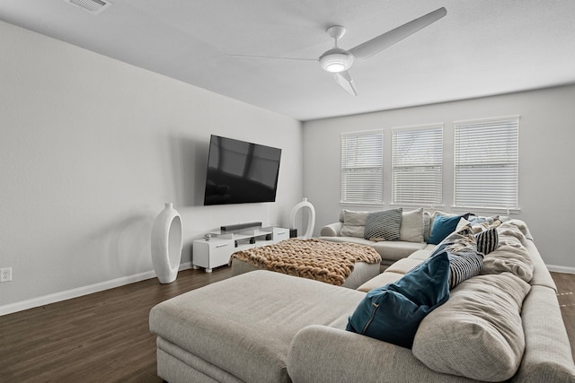 living room with ceiling fan and dark hardwood / wood-style flooring