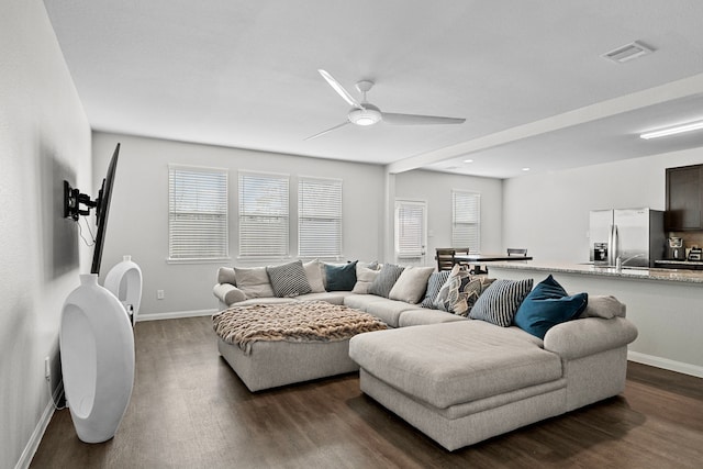 living room with ceiling fan and dark hardwood / wood-style flooring