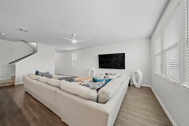 living room featuring wood-type flooring and ceiling fan