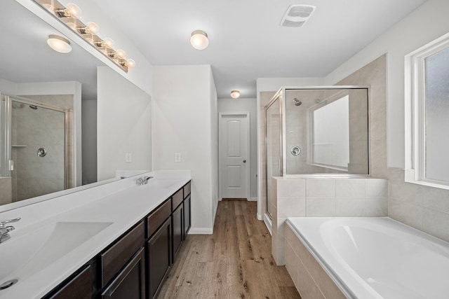 bathroom featuring vanity, wood-type flooring, and independent shower and bath