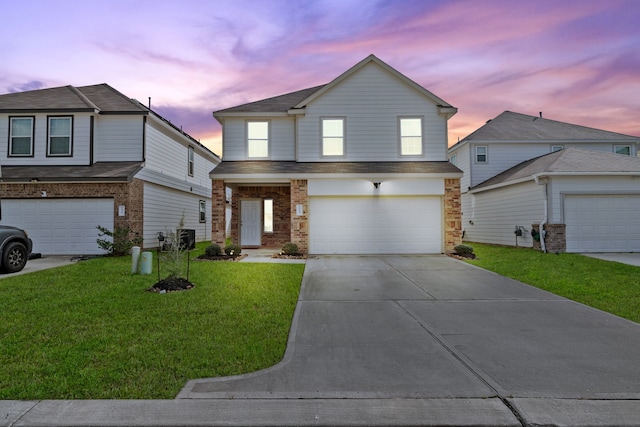 view of front of property with a garage and a lawn