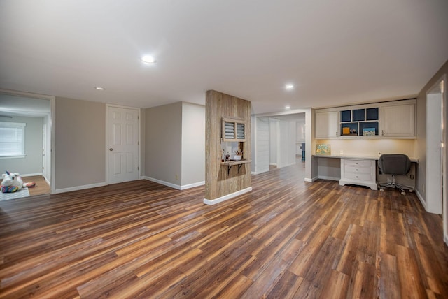 interior space with built in desk and dark hardwood / wood-style floors