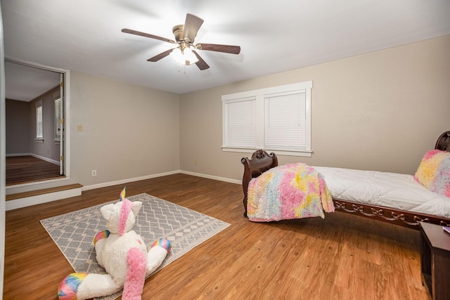 bedroom with hardwood / wood-style floors and ceiling fan