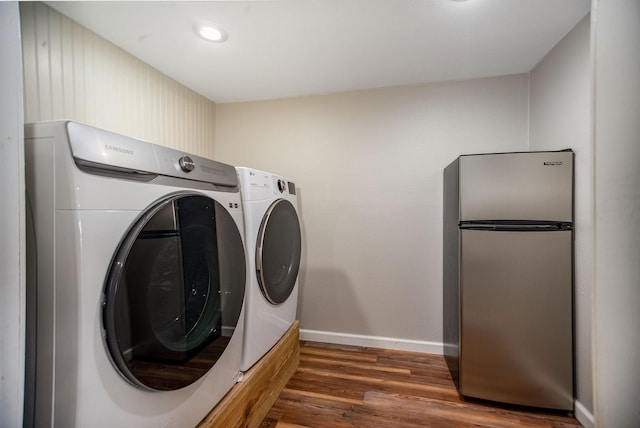 laundry area featuring dark wood-type flooring and washer and dryer