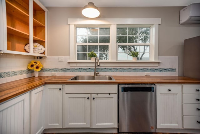 kitchen featuring white cabinetry, sink, wooden counters, and dishwasher