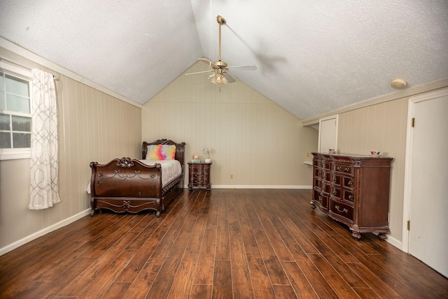 bedroom featuring dark wood-type flooring, ceiling fan, vaulted ceiling, and a textured ceiling